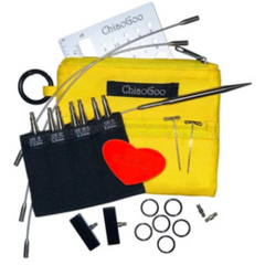 ChiaoGoo knitting needle set with yellow case, needles, and accessories on a white background